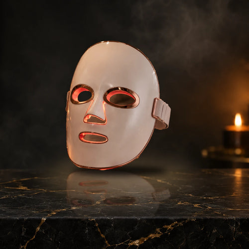 Aura Glow Pro LED mask, white rose gold edge finish, on black marble vanity